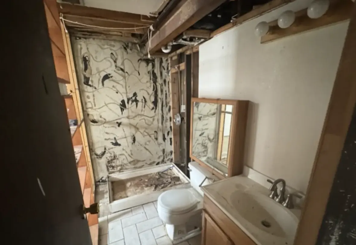 Bathroom of an Arvada, Colorado house bought as-is by Windcrest Investments, before